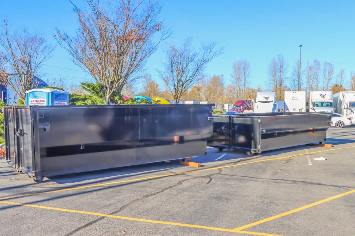 Professional dumpster rental service with roll-off container on residential driveway in Country Walk